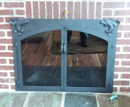 Chatham Square to Arch head of the dragon has two dragon heads each corner all black twin doors, with standard forged center handles smoke glass. Comes with slide mesh spark screen.